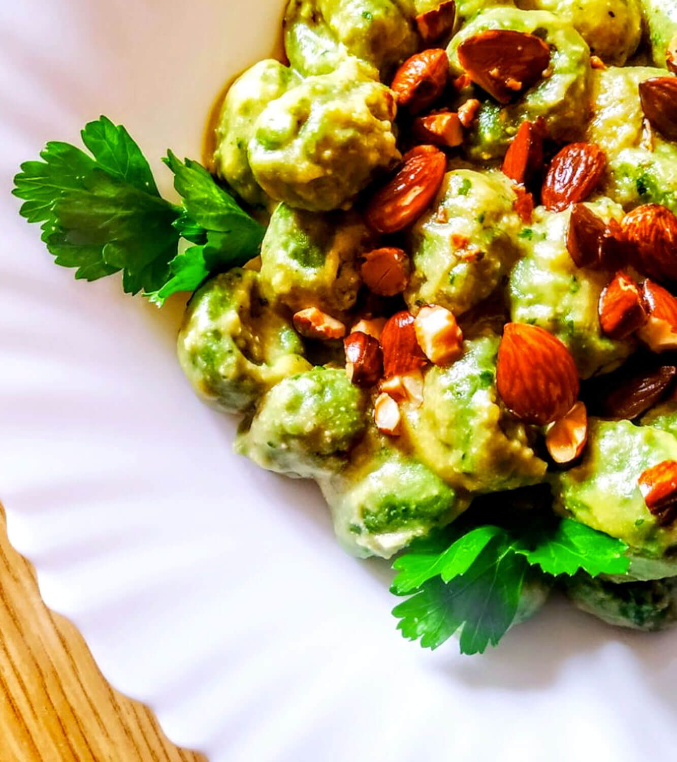 Ricotta and spinach gnocchi with chickpea cream, crispy almonds and parsley