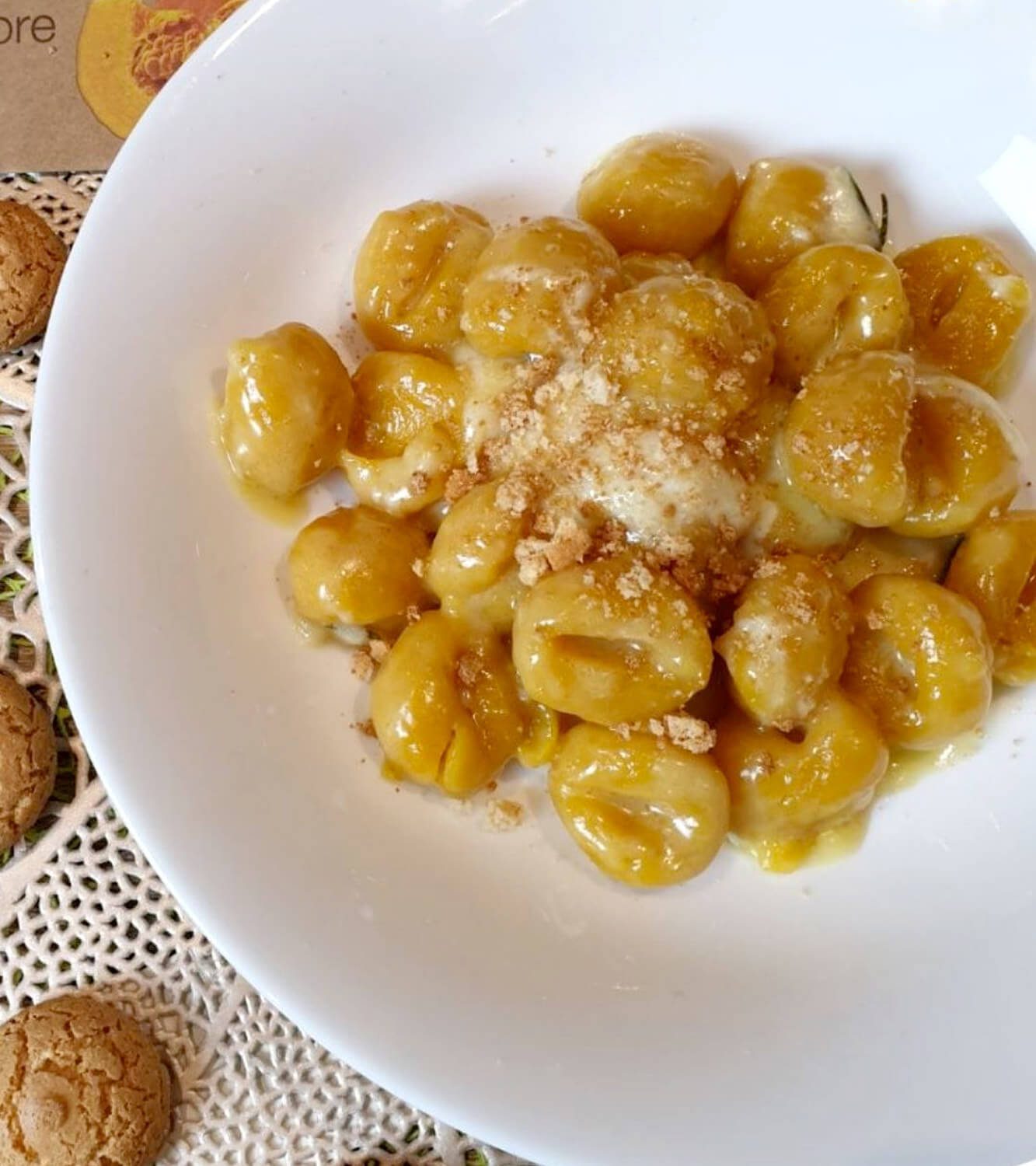 Pumpkin gnocchi in cream of fontina cheese with butter, sage, rosemary and amaretti biscuits