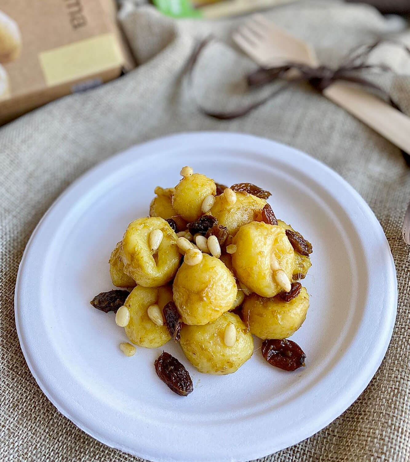 Gnocchi from potatoes with anchovies, pine nuts, raisins and saffron