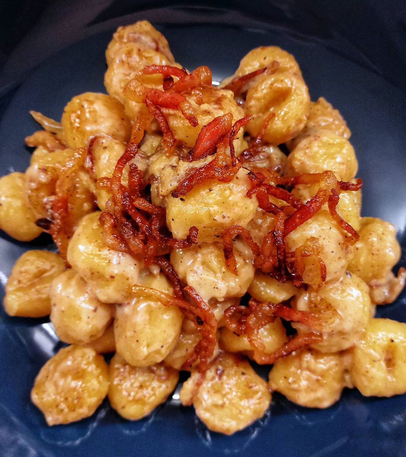 Potato gnocchi carbonara with brandy coated guanciale