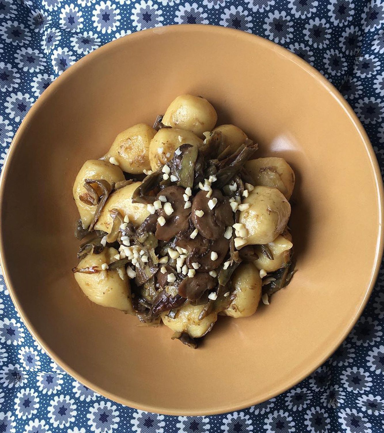 Gnocchi stuffed with Asiago PDO and porcini mushrooms with artichokes, mushrooms and hazelnuts