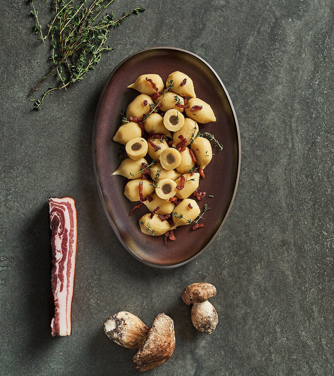 Potato gnocchi filled with asiago cheese and porcini mushrooms with crispy bacon and thyme